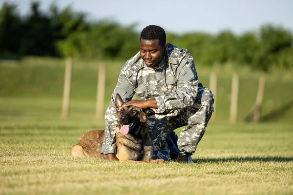 Military dog and his commander enjoying free time at training camp.