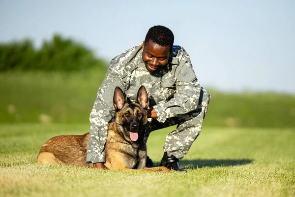 Military dog and his soldier commander enjoying free time at training camp.
