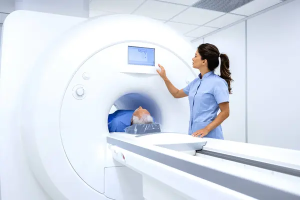 MRI technician radiologist preparing patient for full body examination in hospital diagnostic center.