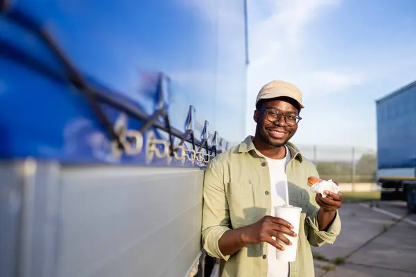 stock image Truck driver eating fast food on lunch break.