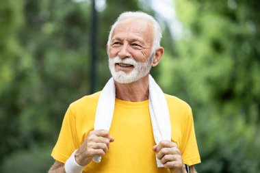 Koşu antrenmanından sonra havluyla Kafkasyalı kıdemli adamın yakın görüntüsü.