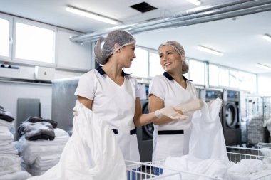 Kirli çarşaf ve çarşaf temizleyen otel çalışanları. Kuru temizleme ve hijyen..