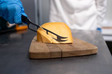 Lezzetli peynirleri dilimliyorum. Profesyonel şef restoranda leziz peynirleri dilimliyor ve yemek hazırlıyor..