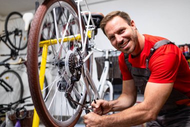 Kırık bisiklet zincirini tamir eden Kafkas askerinin portresi.