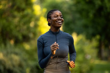 Parkta koşan Afrikalı Amerikalı kadın..
