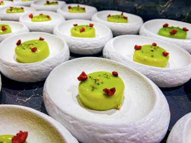 Krem şantili kremalı krema. Fıstıklı ve kurutulmuş ahudududu ile süslenmiş. Bir şenlik, parti ya da düğün organizasyonunda küçük tek ısırıklı keklere 