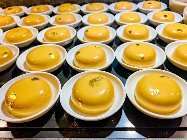 Chocolate or coffee mousse, decorated with edible gold,is thinnest foil made of precious metals,which has neither taste nor smell.at catering event on festive event,party or wedding reception. buffet
