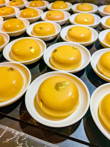 Chocolate or coffee mousse, decorated with edible gold,is thinnest foil made of precious metals,which has neither taste nor smell.at catering event on festive event,party or wedding reception. buffet