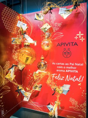 Porto, Portugal - December 6, 2022: Festive Christmas and New Year advertising composition of Apivita company in red colors in store, mall