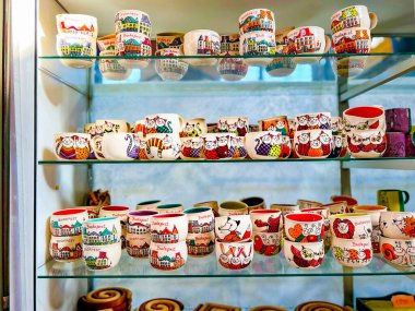 Budapest, Hungary, February 9, 2023. Sale of cute souvenir cups. They stand on glass shelves, showcase