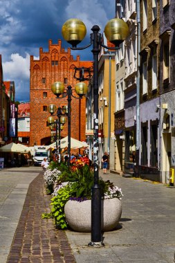 Olsztyn, Poland, August 10, 2022. The road to the high gate is the only medieval gate in Olsztyn through which you can also enter the city. clipart
