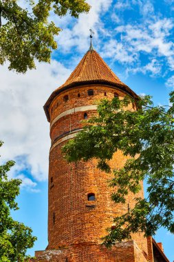 Olsztyn, Poland, August 10, 2022. main tower in the castle of the Warmia Chapter. The castle was erected in a naturally defensive place, on a hill in a wide bend of the Lyna River.