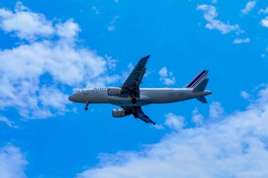 Santorini, Greece - July 09, 2022: Air France plane flies in the sky. stylized as AIRFRANCE, is the flag carrier of France headquartered in Tremblay-en-France.