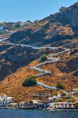 The island of Tyracia is famous for its seafood restaurants, where tourists are brought to dine after an excursion to the volcano. Near the island of Santorini, Greece. Summer warm weather