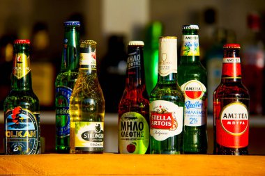 Santorini, Greece - July 09, 2022: Beer in bottles of different brands in a bar on the counter