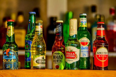 Santorini, Greece - July 09, 2022: Beer in bottles of different brands in a bar on the counter