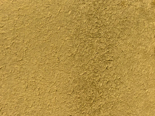 gold plated oriented strand board. texture. surface rough to the touch