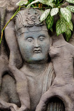 Statue of a meditating Buddha is made of stone