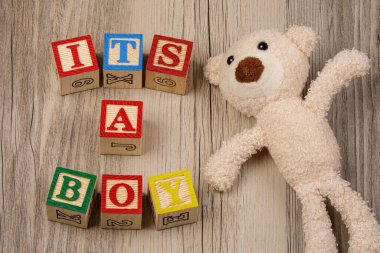 A Baby Shower invitation for a baby boy on wooden background