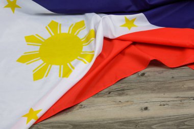 Philippine Flag draped over a wooden background with copy space