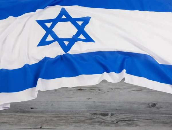 Close up of the Israeli Flag with the Star of David with wooden background and copy space