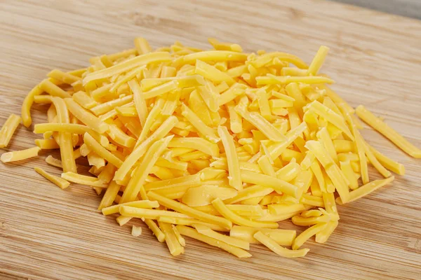 Close Delicious Grated Cheddar Cheese Wooden Background Copy Space — Stock Photo, Image