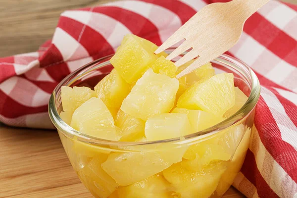 stock image A close up of delicious Pineapple Chunks is juicy Syrup on a wooden background with copy space