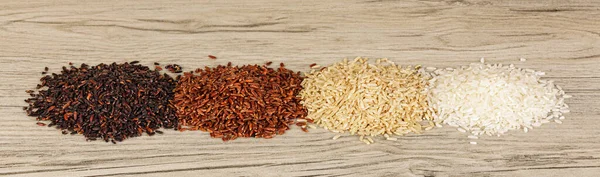 Four Different Types Rice Black Red Brown White Wooden Background — Stock Photo, Image