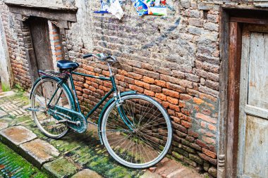 Güney Asya, Katmandu Nepal yakınlarındaki Bhaktapur kasabasında bir bisiklet bir duvara dayanır.