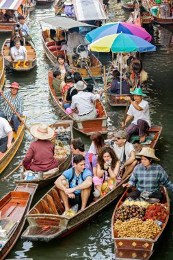 Güneydoğu Asya 'daki Bangkok Tayland' ın yaklaşık 62 mil açığındaki Damnoen Saduak yüzer pazarında yiyecek ve hediyelik eşya satıyor.