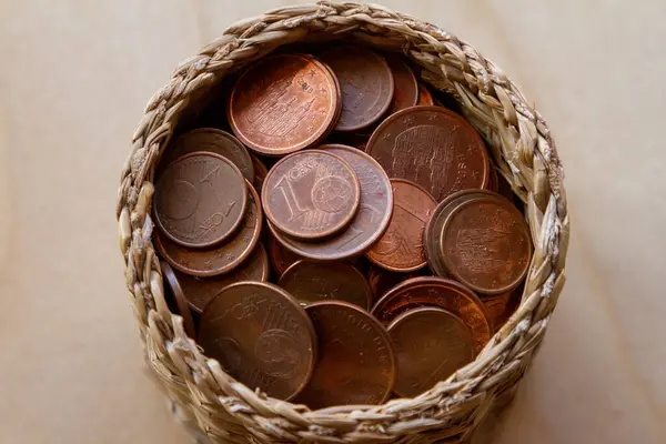 stock image euro coins inside a basket on a wooden background, 