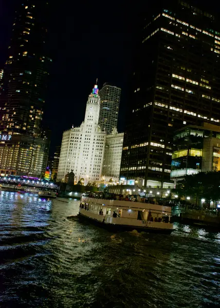 stock image Wrigley building lit up at night overlooking the Chicago river