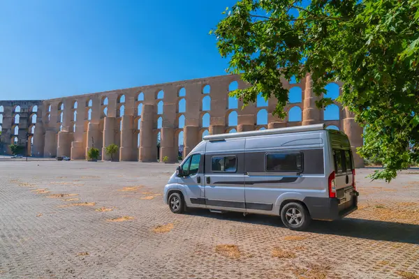 stock image Campervan parked under a tree by Elvas Aqueduct Portugal Portuguese landmark