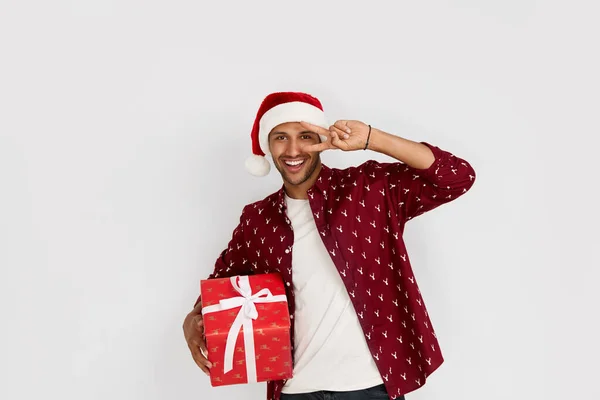 stock image Happy Man Holding Present. Excited Multiracial Guy Holding in Hands Wrapped Present Box with Excitement. New Year Concept. Indoor Studio Shot White Background 