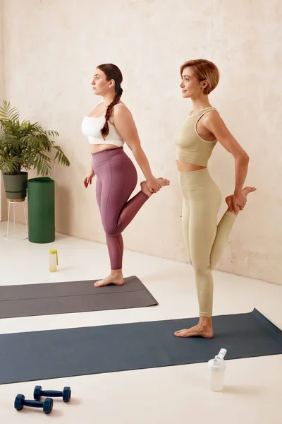 Positive Women Training Yoga Girls Sportswear Stretching Legs Exercising Home — Stock Photo, Image