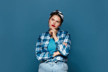 Thoughtful Woman Pondering At Studio. Serious Girl Thinking Serious Issues, Looking With Uncertain Expression, Making Difficult Choice. Indoor Studio Shot Isolated