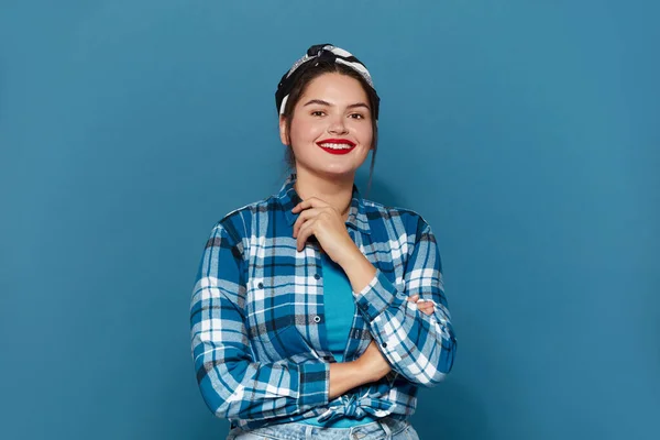 Plus Size Woman Smiling Isolated. Portrait of Bossy Woman Looking at Camera, Feeling Confident, Posing. Indoor Studio Shot Isolated on Blue Background