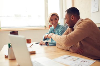 Smiling Colleagues Bumping Fists At Office. Couple Of Happy People Having Fun Sitting Laptop Table. Happy Man Woman Celebrating Achievement 