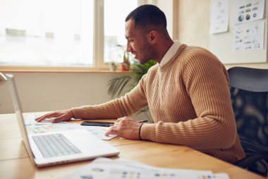 Smiling Businessman Working Office. Positive Guy Examining Documents at Computer Table. Male Person Sitting At Workplace In Modern Office. Career Concept 