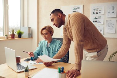 Serious Businesspeople Working Computer At Office. Smart Colleagues Couple Discussing Laptop Screen In Modern Office. Teamwork Concept