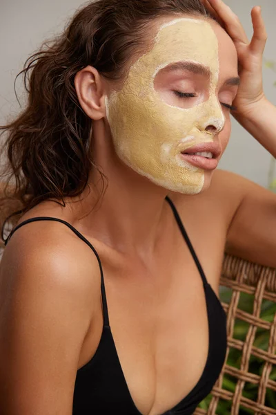 Face Mask Woman. Young Relaxed Woman Enjoying Skin Care Routine at Street. Attractive Woman With Makeup And Clay Mask On Her Skin. Spa Procedure Concept