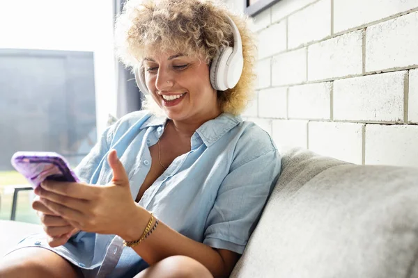 Cheerful Young Woman Curly Hair Listens Music Her White Headphones — Stock Photo, Image