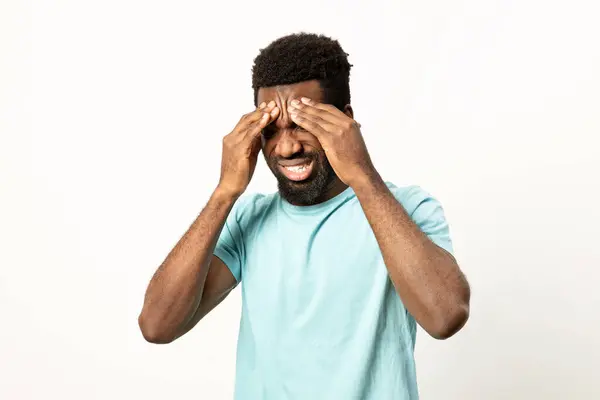 Young Man Blue Shirt Looks Overwhelmed Covering His Face Hands — Stock Photo, Image