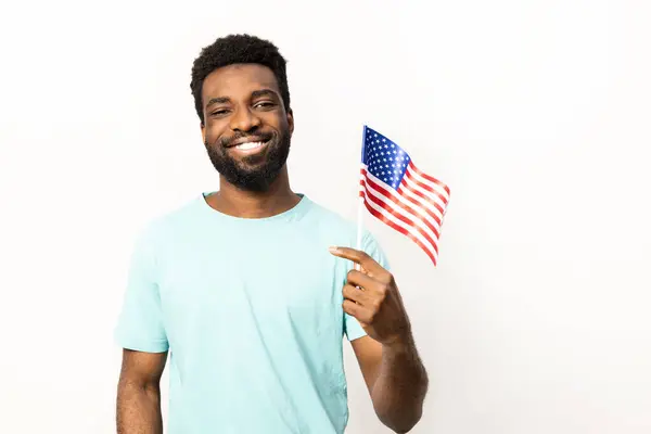 Afroamerikaner Lächelt Während Eine Amerikanische Flagge Der Hand Hält Die — Stockfoto
