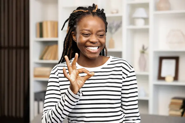 Happy Woman Gesturing Sign Home Afro American Female Striped Shirt — Stock Photo, Image