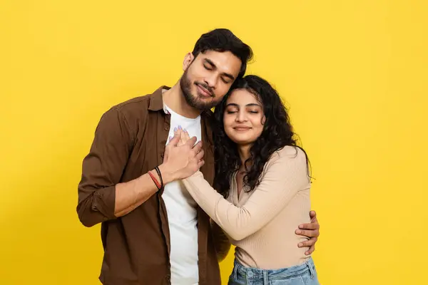 Loving Couple Embracing Yellow Background Expressing Affection Comfort Casual Outfits — Stok Foto