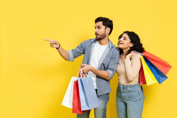 Couple Shopping Happiness Retail Sale Consumer Purchase Yellow Background Pointing — Stock Photo, Image