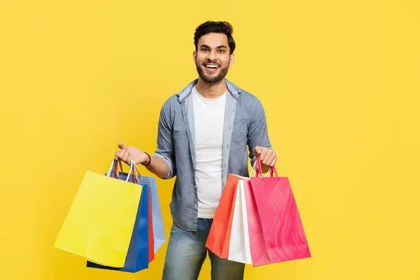 Smiling Young Adult Holding Variety Brightly Colored Retail Bags Exuding — Stok Foto