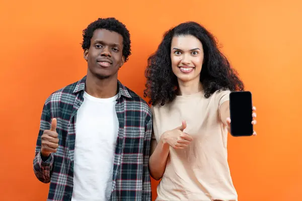 Young Couple Holding Smartphone Blank Screen App Promo Orange Background — Stock Photo, Image