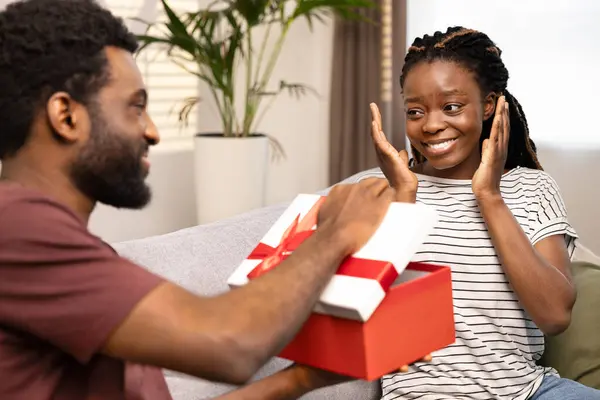 Surprise Gift Exchange Happy Couple Home Joyful Woman Receiving Red — Stock Photo, Image